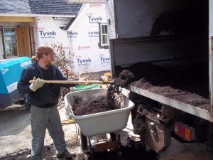 Shamar shoveling out compost for the Maple trees.